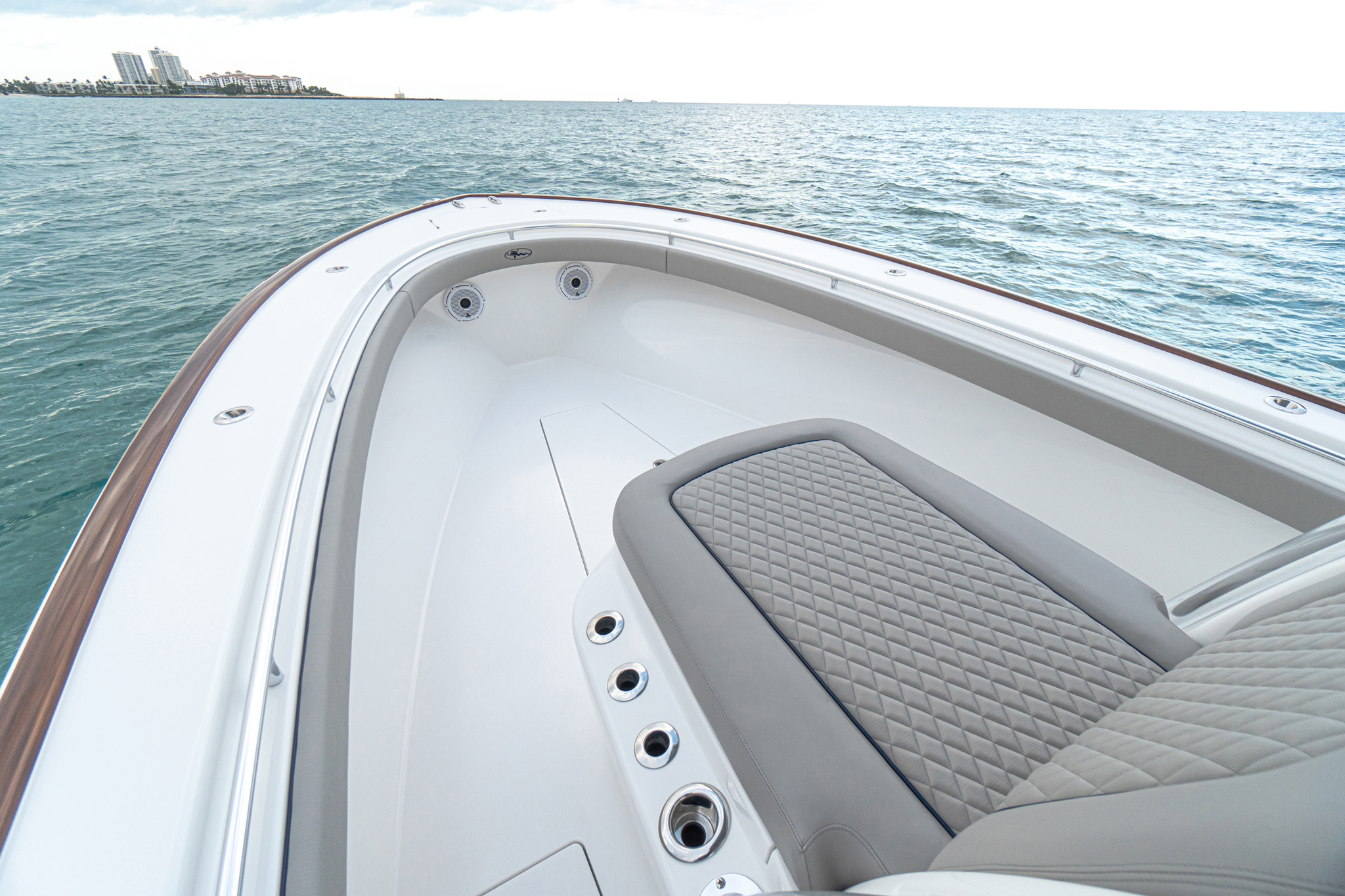 Available faux teak toe rail; forward lounge seating with available Bentley stitching.