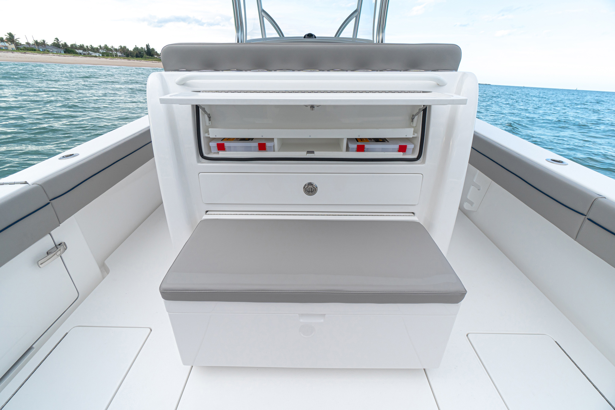 Aft seating module with pull-out cooler, tackle and drawer storage.