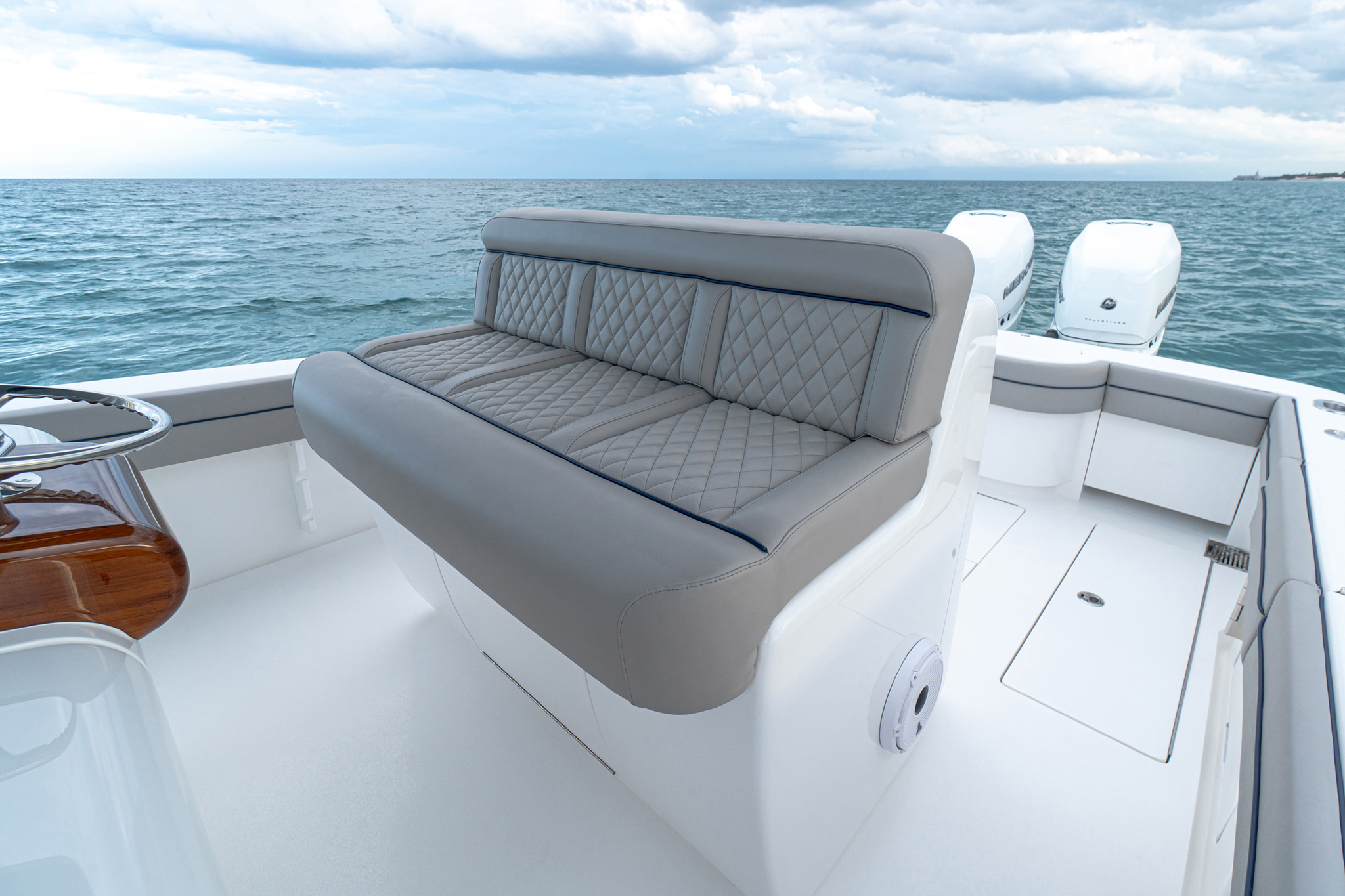 Three-person Costa Marine bench seating with available premium upholstery, Bentley stitching.