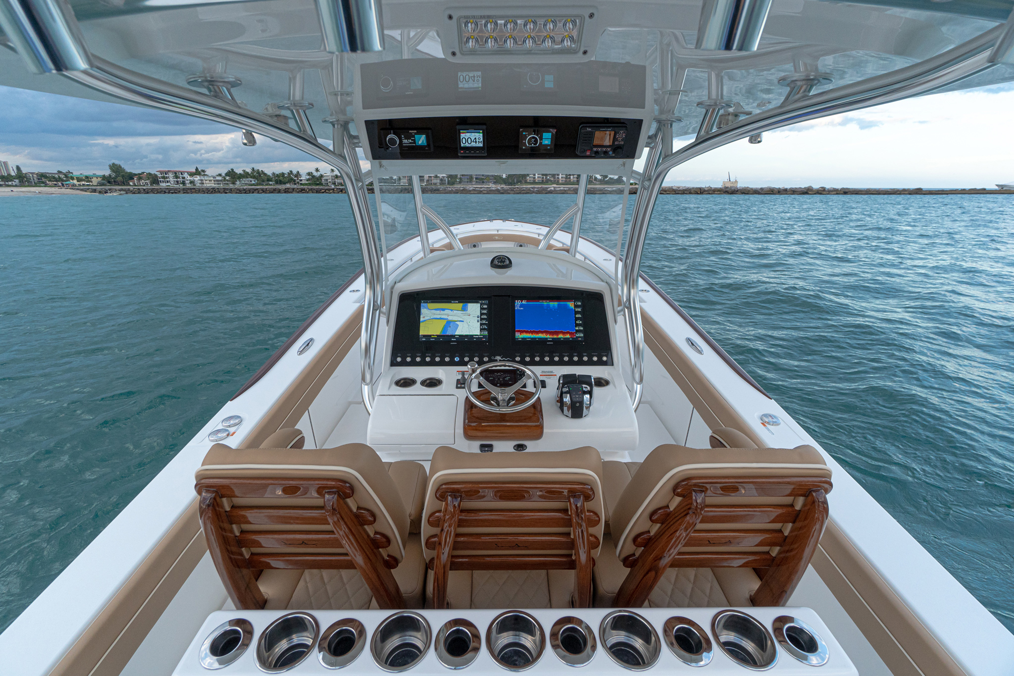 Available Release Marine teak helm pod, recessed electronics displays, intuitively located Bocatech switches.