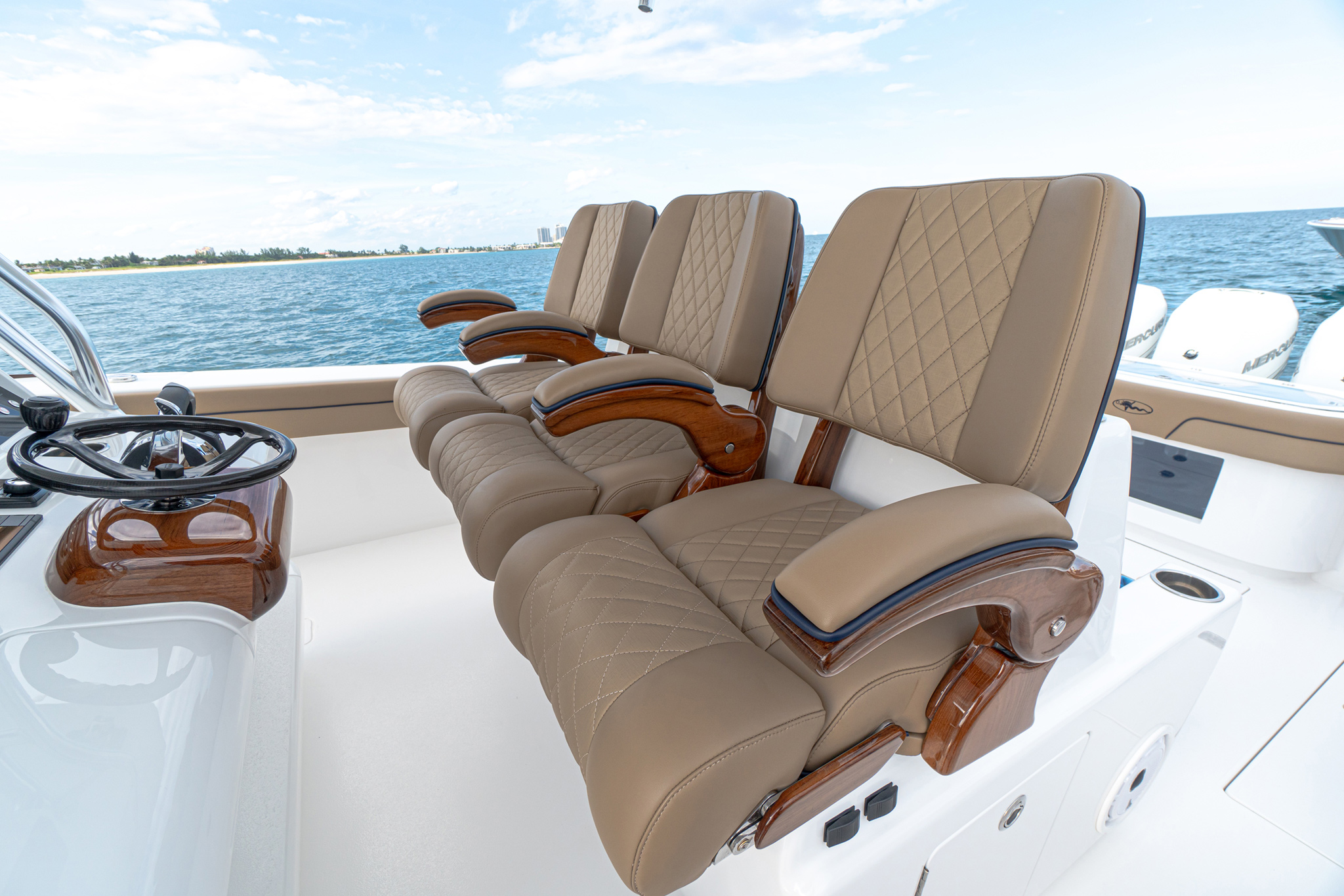 Premium upholstery with Bentley stitching and teak armrests.