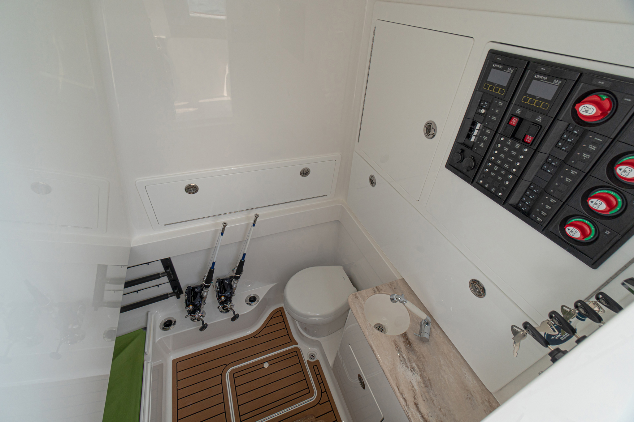 Console’s electric head, vanity with sink/shower wand, electrical panel, electronics access, available SeaDek floor.