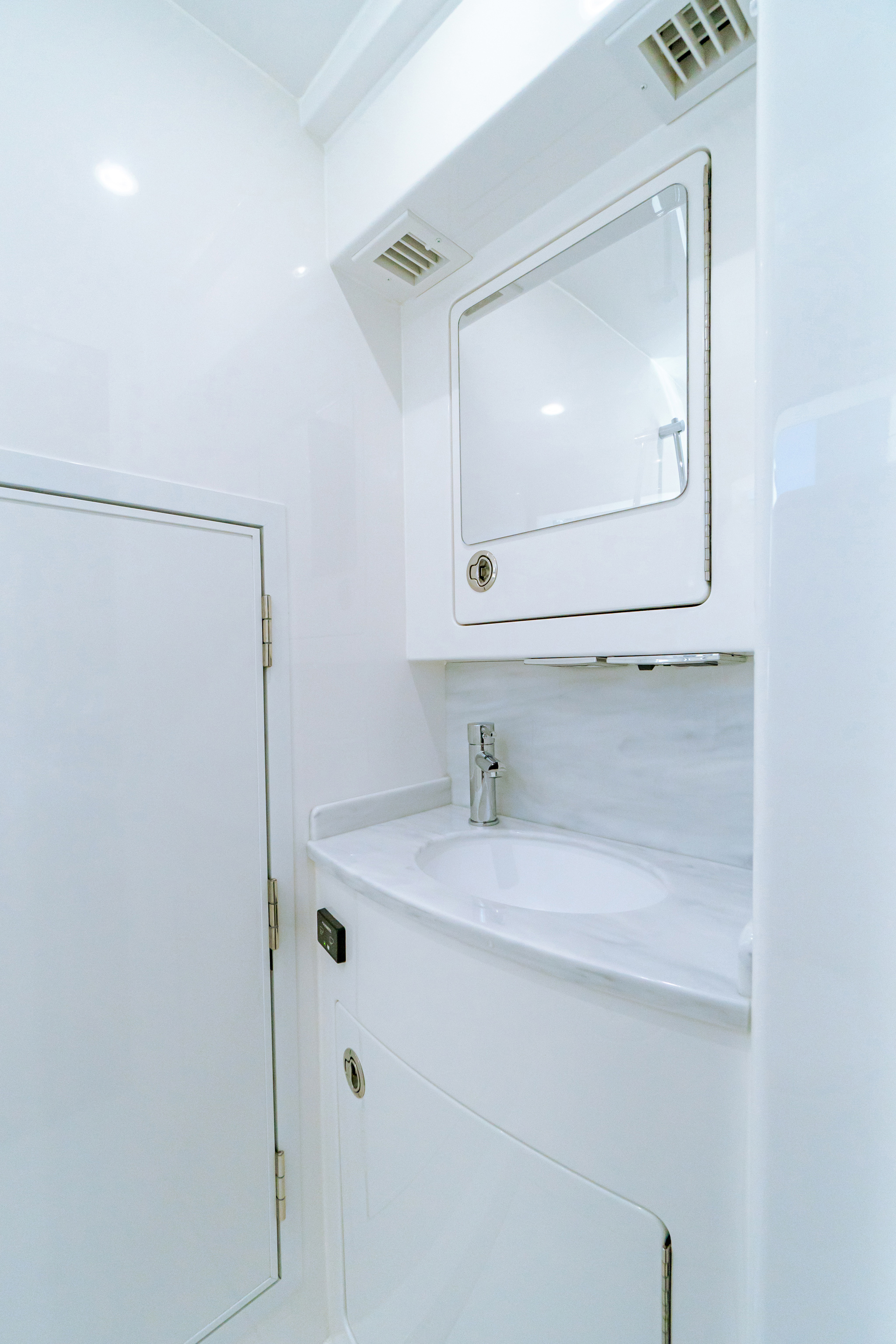Enclosed head with molded-in vanity, sink, shower, access to machinery room.